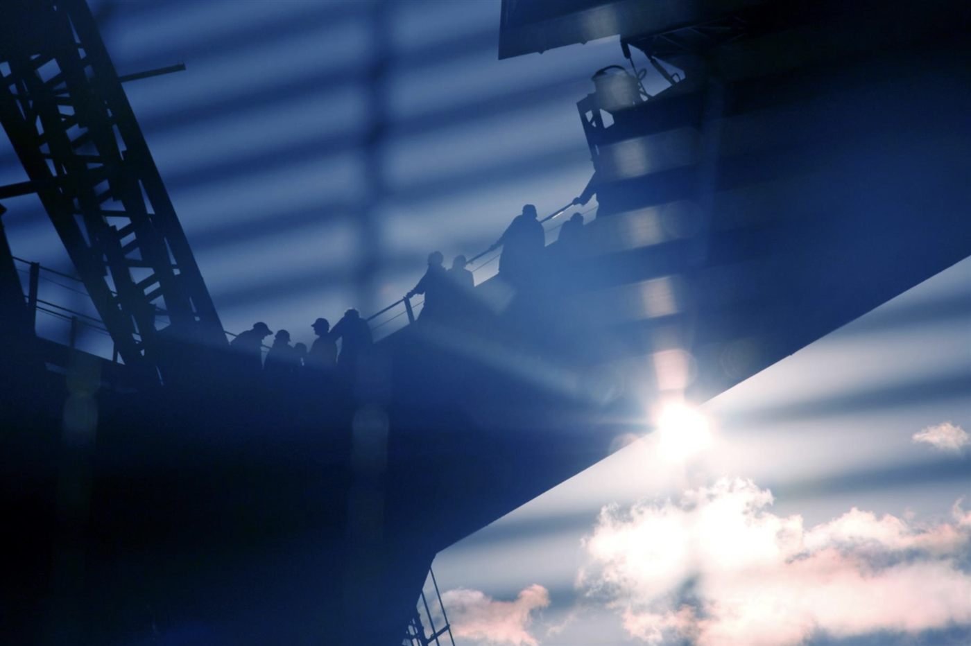 Workers on industrial infrastructure in silhouette